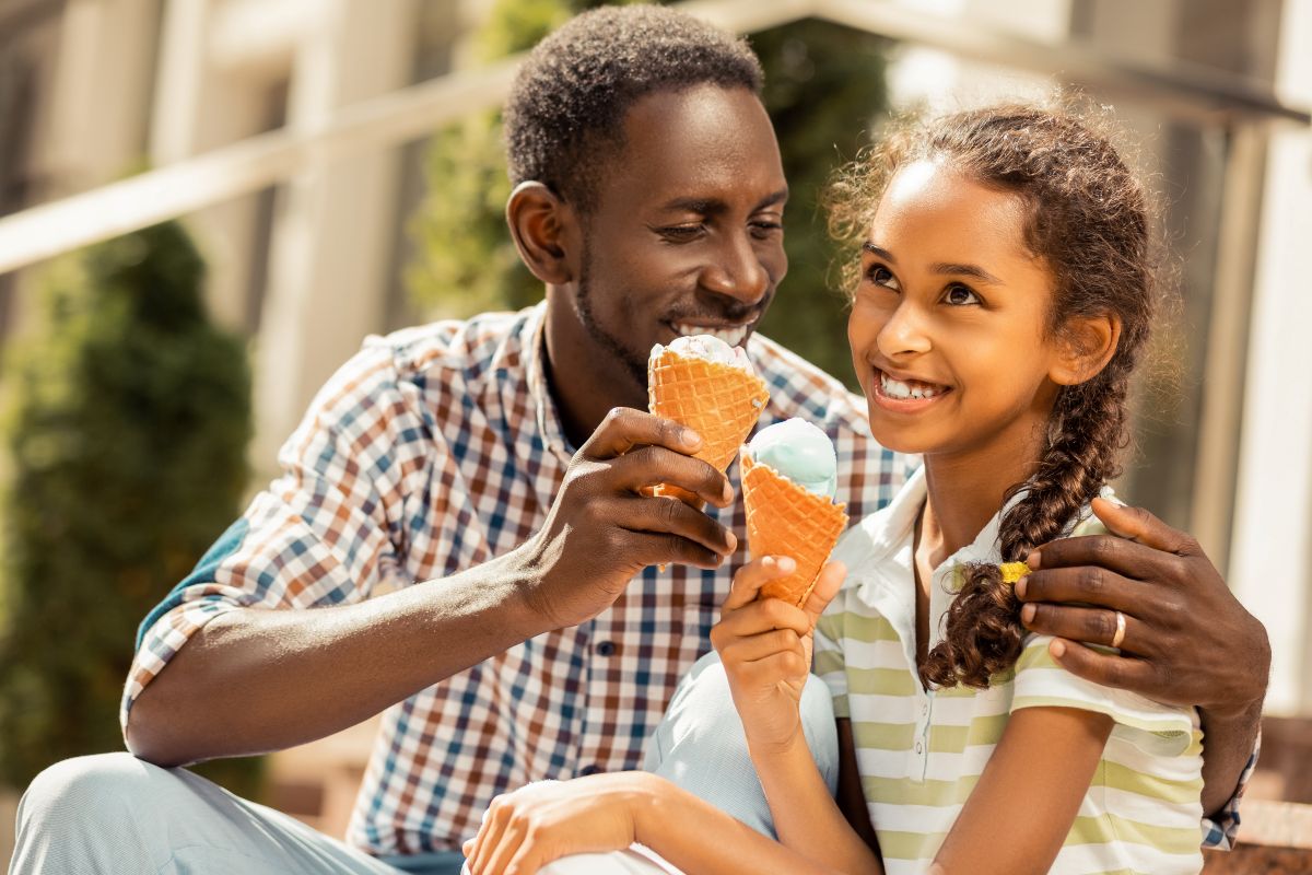 father and daughter eat ice cream together